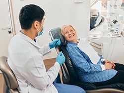 Dentist consulting with senior patient