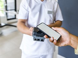 Dental team member accepting payment from patient