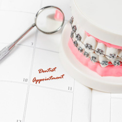 Dental model with braces on top of a calendar