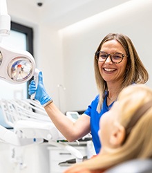 Happy dental team member interacting with patient