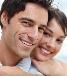 Man and woman with healthy smile after dental exam and teeth cleaning