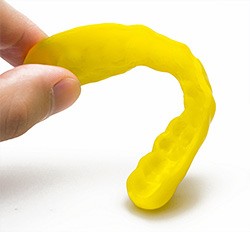 Person holding a custom mouthguard
