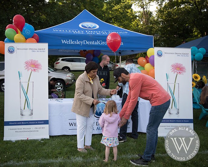 Dentist talking to community members at event