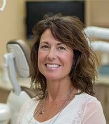 Happy, smiling woman in dental clinic setting