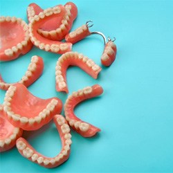 Multiple types of dentures against blue background