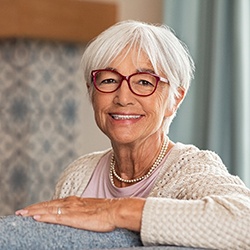 Senior woman smiling after full mouth reconstruction in Wellesley