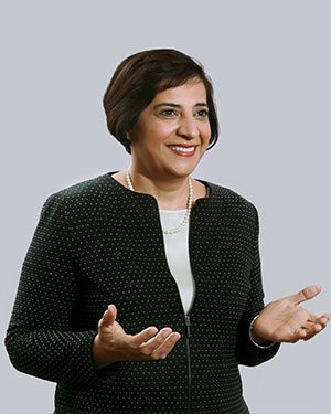 Dr. Femina Ali smiling and holding her hands out