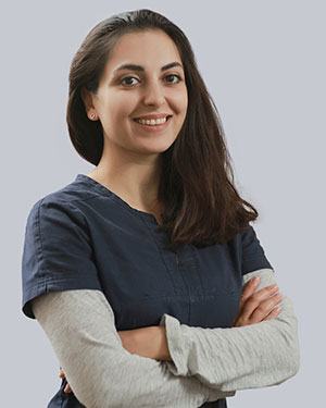 Farnaz smiling with her arms crossed