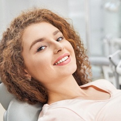 Happy female dental patient attending appointment for veneers