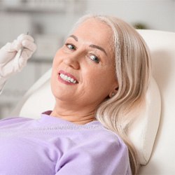 Smiling, mature dental patient, showing veneers in Wellesley