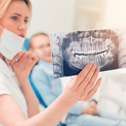 Dental team member looking at X-ray with wisdom teeth