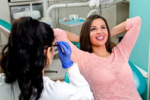 Smiling dental patient relaxing in treatment chair