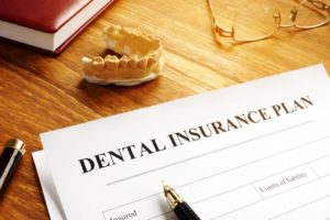 Dental insurance plan document on desk