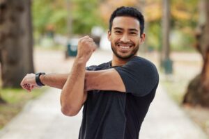 Happy, smiling man exercising outdoors 